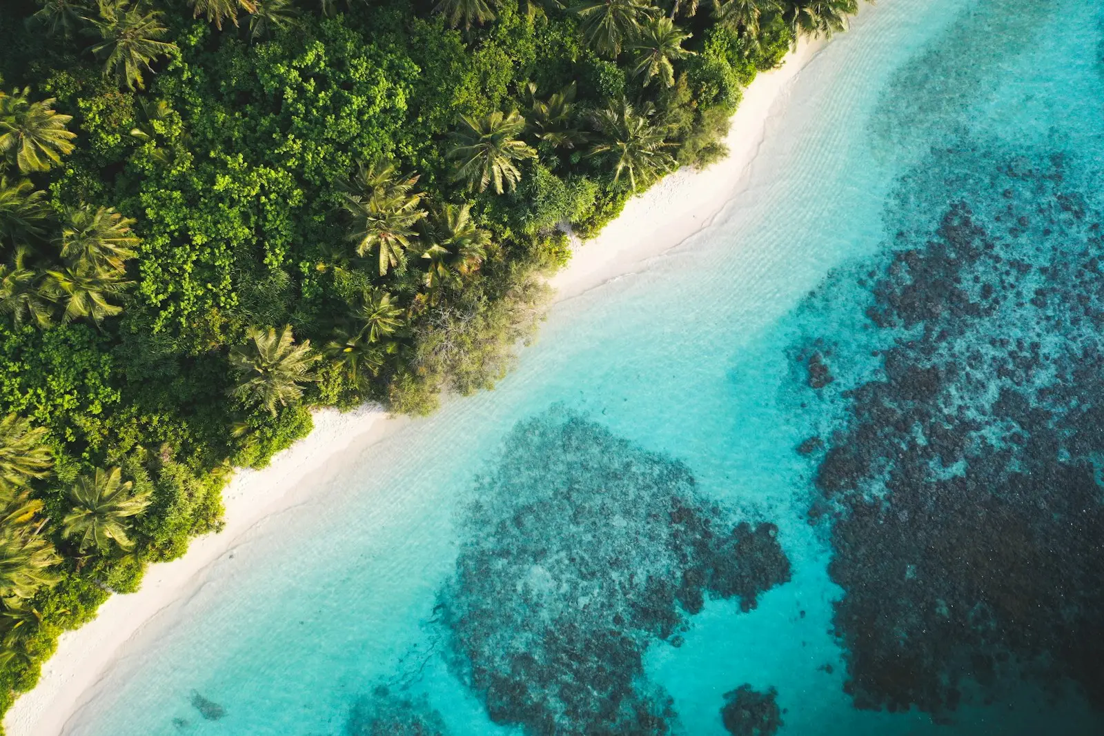 Turquoise lagoon and white sand beach seen from above