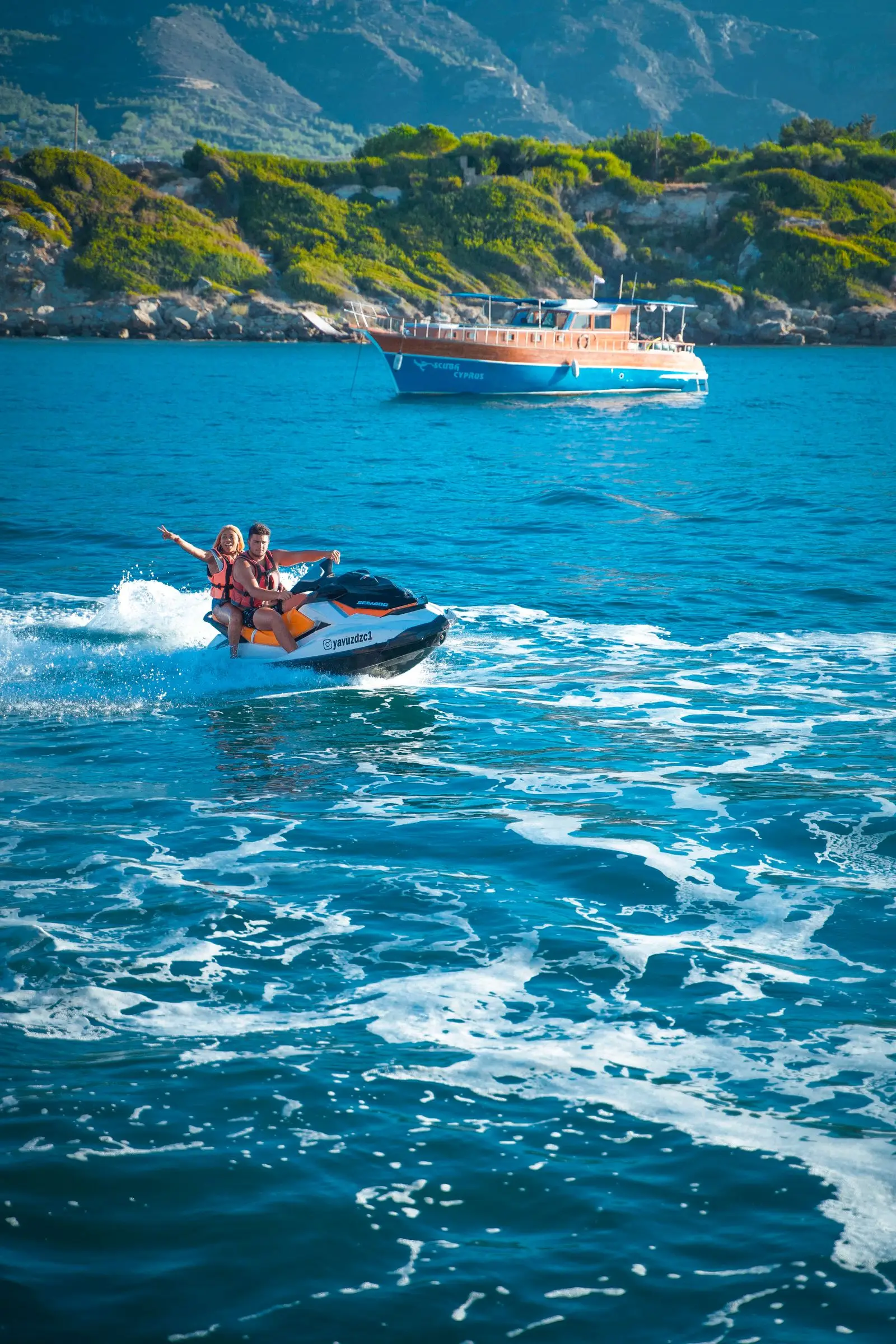 Couple riding a jet ski together out on open water